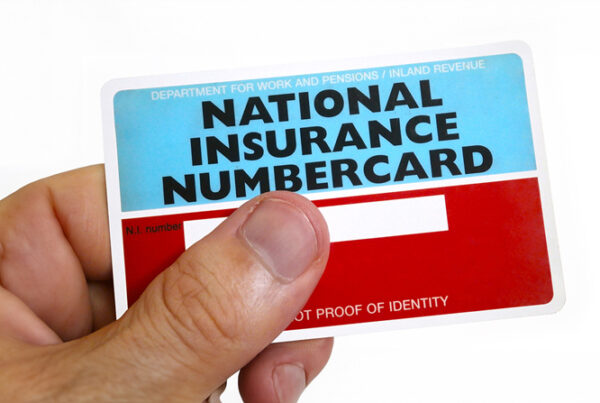 Man holding a National Insurance Numbercard to demonstrate National Insurance Contributions.